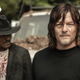 Daryl, in a black sweater, barrels the camera while Gabriel, in a black hat and blood-spattered t-shirt, looks to the left.